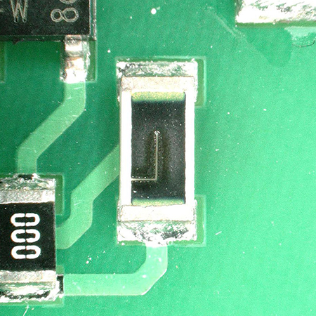 Electronic resistor on a printed circuit board with an L-cut laser trimmed with a laser trimmer from ACI
