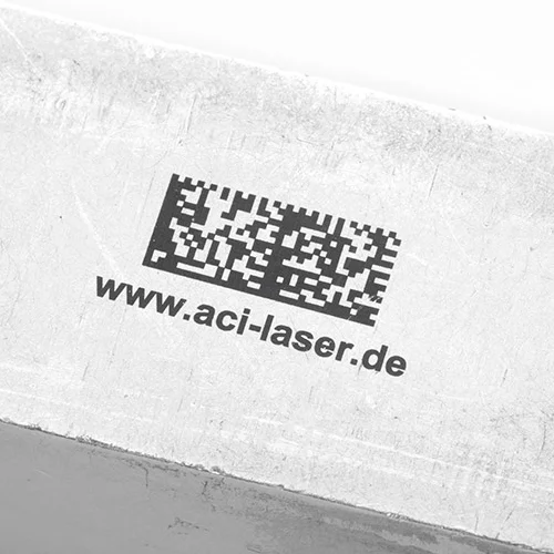 Black lettering of text and data matrix on aluminum block